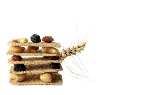 Stack of slices crispbread with nuts, raisins and spikelet wheat Stock Photos