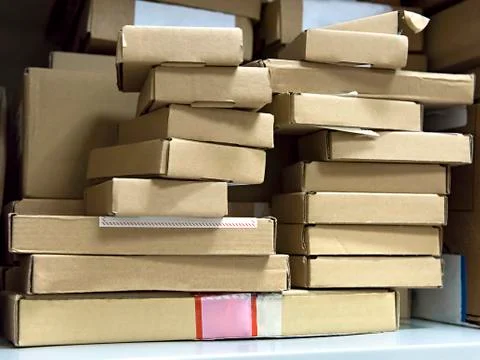 Stack of small cardboard boxes on a shelf Stock-Fotos