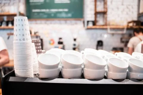 Stack of small ceramic cups on shelf. Stock Photos