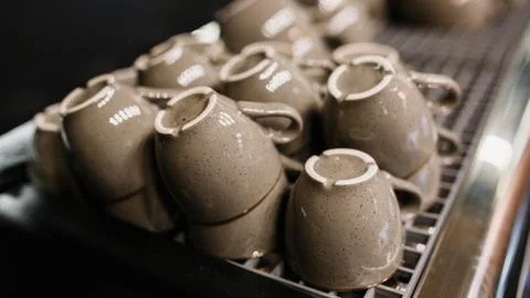 Stack of small ceramic cups on shelf. Pile of Clean ceramic coffee cups. 스톡 사진
