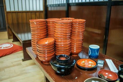 A stack of small empty red Morioka Wanko Soba bowls Stock Photos