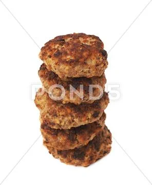 Stack of small hand made cutlets isolated over white background Stock Photos