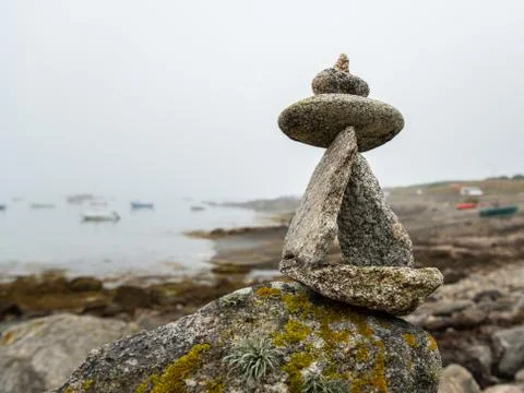 Stack of small rocks near the sea on a foggy day in summer Stock Photos