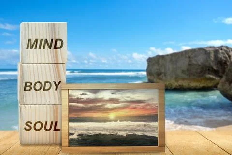 Stack of small wooden cubes with the text of mind, body, and soul with a sm.. Stock Photos