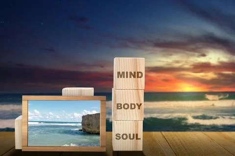 Stack of small wooden cubes with the text of mind, body, and soul with a sm.. 写真素材