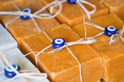 Stack of soap topped with evil eye beads, Stockfoto's