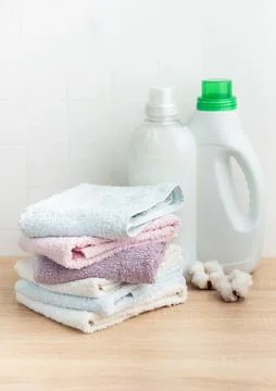 Stack of soft clean towels with laundry detergents Stock Photos