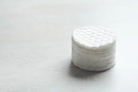 Stack of soft cotton pads on light background, space for text 스톡 사진