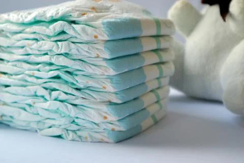Stack of soft new baby diapers. Pastel color. Closeup. Stock Photos