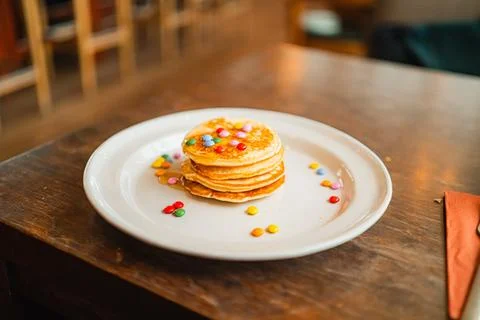 Stack of Soft Pancakes with Honey and Chocolate Lentile Topping Stock Photos