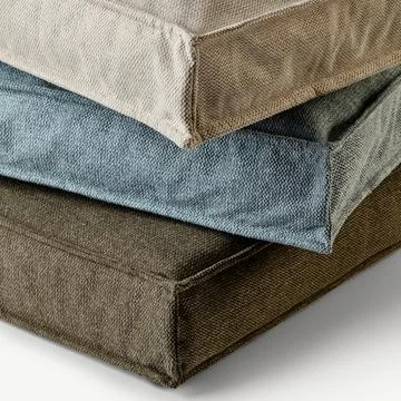 Stack of soft square cushions in natural colors creating relaxing atmosphere Stock Photos