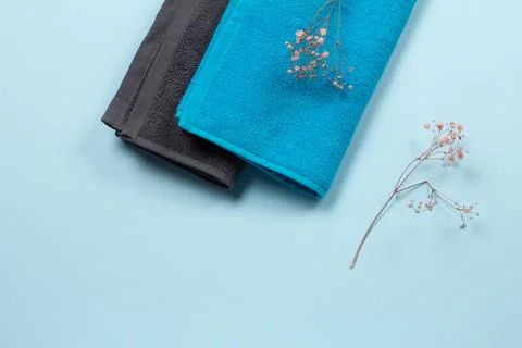 Stack of soft terry towels on blue background. Stock Photos