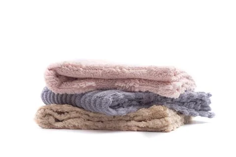 Stack of soft terry towels in pastel colors isolated on a white background. C Stock Photos