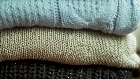 Stack of Soft Warm Knitted Woolen Sweaters Sweatshirts Cozy Plaids Clothes Texti Stock Footage 220069586
