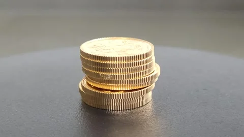 A stack of solid gold British Sovereign coins rotate Stock Footage 244924926