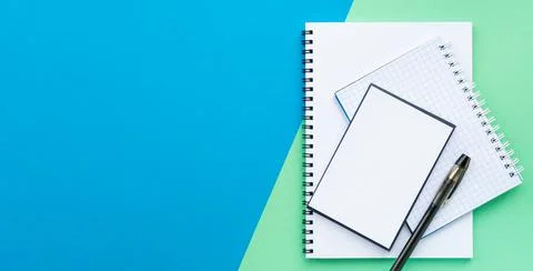 Stack of spiral notebook, notepad, notepaper, black pen. Banner. Stock Photos