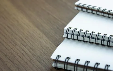 Stack of spiral notebook on wood table Stock Photos