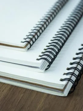 Stack of spiral notebook on wood table Stock Photos