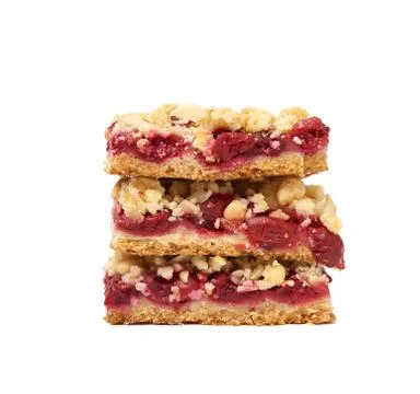 Stack of square baked slices of cramble with red cherry Stock Photos