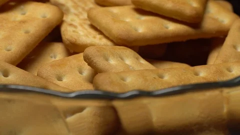 Stack of square crackers on a black background in rotation. Crackers spin. Stock Footage 99945046