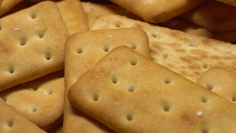 Stack of square crackers on a black background in rotation. Crackers spin. Stock Footage 99945337
