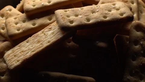Stack of square crackers on a black background in rotation. Crackers spin. Stock Footage 99945470