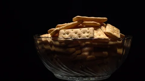 Stack of square crackers on a black background in rotation. Crackers spin. Stock Footage 99945492