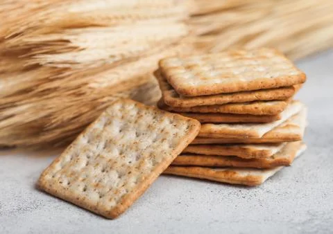 Stack of square organic crispy wheat and corn flatbread crackers with sesame Stock Photos