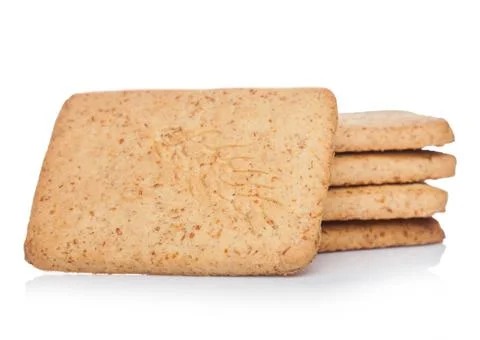 Stack of square organic crispy wheat and five grain salty crackers on white Stock Photos
