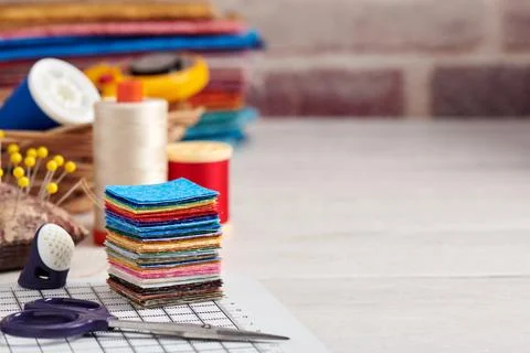 Stack of square pieces of colorful fabrics, accessories for quilting Stock Photos
