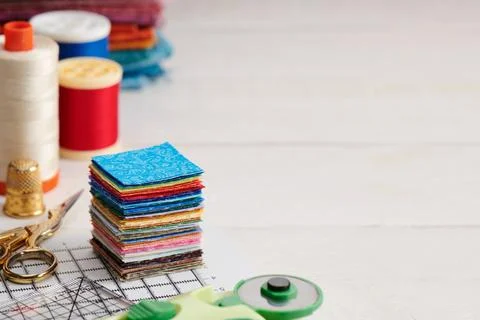 Stack of square pieces of colorful fabrics, accessories for quilting Fotos de archivo