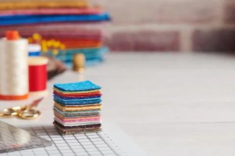 Stack of square pieces of colorful fabrics, accessories for quilting 스톡 사진