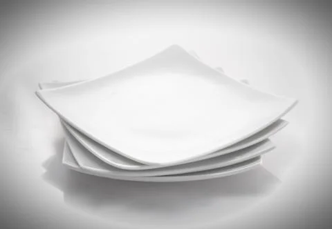 Stack of square plates isolated on a white background Stock Photos