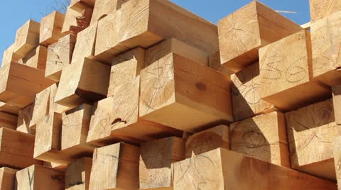 Stack of square wooden chips at construction yard. Dolly pan shot, blue sky Vídeo Stock 24441131