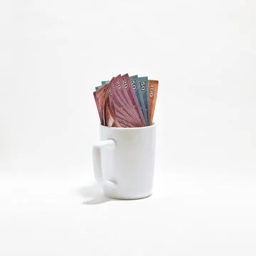 Stack of Sri Lankan Rupee Banknotes in Blank Ceramic Mug Stock Photos