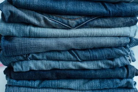 Stack of a stack of old jeans various shades of blue jeans. Denim jeans tex.. Stock Photos