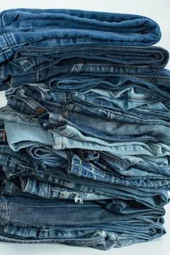 Stack of a stack of old jeans various shades of blue jeans. Denim jeans tex.. Stock-Fotos