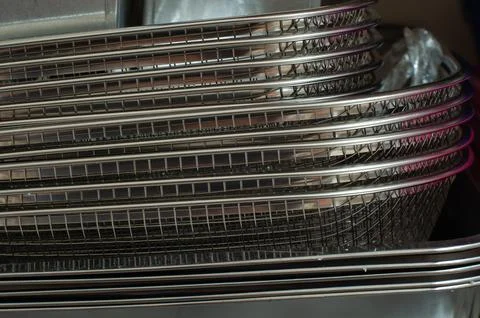 Stack Of Stainless Steel Baking Trays And Wire Baskets On Kitchen Rack Stock Photos