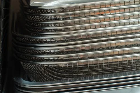 Stack Of Stainless Steel Baking Trays And Wire Baskets On Kitchen Rack Stock Photos