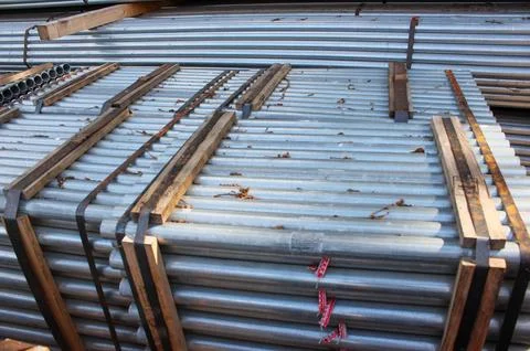 Stack of stainless steel round pipes. Metal pipes background Stock Photos