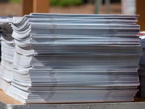Stack of stapled periodicals sitting in a stack Stock Photos