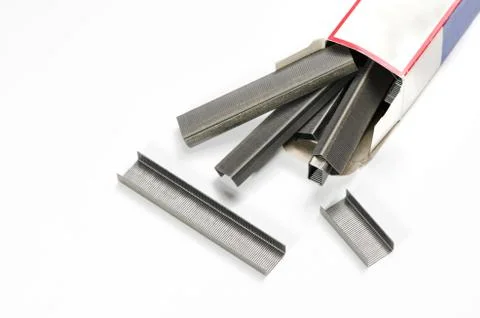 Stack of stapler's wires and paper box. Stock Photos
