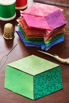 Stack of stitched diamonds like a cube and three diamonds, which will be se.. Stock-Fotos