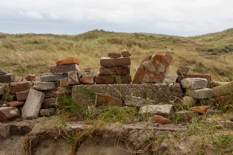 Stack of stone bricks as still life in the dune landscape Stock Photos