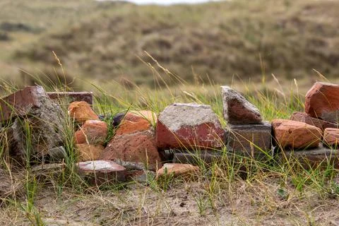 Stack of stone bricks as still life in the dune landscape Stock Photos
