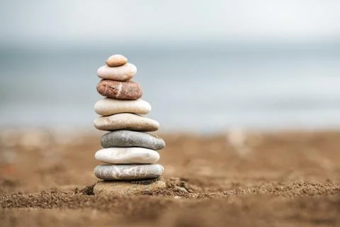 Stack of Stone over the sand. Balance and stability concept with stones. Stock Photos
