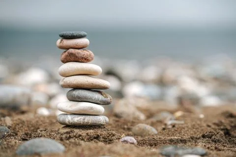 Stack of Stone over the sand. Balance and stability concept with stones. Stock Photos
