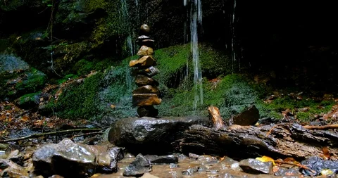 Stack of Stones at Amazing Jungle Waterfall Stock Footage 125773274