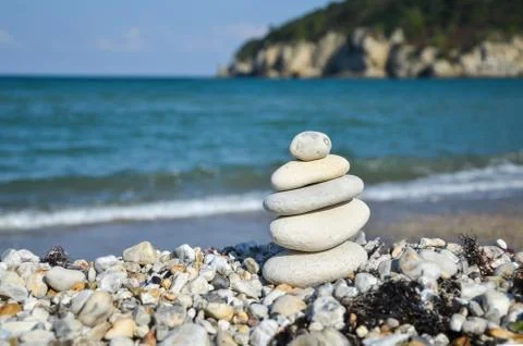 Stack of stones on the  beach in summer. Stock Photos