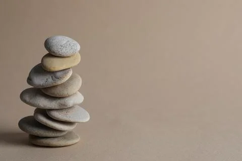 Stack of stones on beige background, space for text. Harmony and balance conc Foto stock